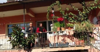 Zarif Inceler and his wife, Fatma Inceler, look down from the balcony of their house, Adana, Türkiye, March 20, 2023. (IHA Photo)