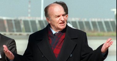 Bosnian President Aljia Izetbegovic gestures upon his arrival at Ciampino airport, Rome, Italy, Feb. 17, 1996. (AP Photo)