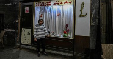 Madam Lucie, an 88-year-old manicurist expert, poses for a picture at her manicure shop in downtown Cairo, Egypt, Nov. 18, 2024. (AFP Photo)