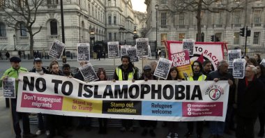 People hold up a banner during a &#039;Unity Vigil&#039; against racism and Islamophobia in reaction to Wednesday&#039;s attack, backdropped by the gates of Downing Street in London, Friday, March 24, 2017. (AP File Photo)