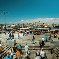 People walk in Eminönü, famous for fish and bread boats, Istanbul, Türkiye, June 20, 2021. (Shutterstock Photo)