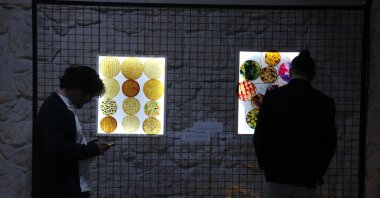 Visitors explore the vegan leather fabrics made from used tea at Seyhan Çırçır Art Center, Adana, Türkiye, March 23, 2025. (AA Photo)