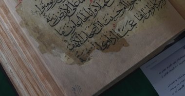 An ancient copy of the Quran is displayed in a glass case, Sulaymaniyah, Iraq, April 4, 2025. (AA Photo)