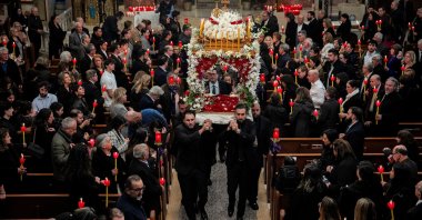 Members of the Greek Orthodox community carry an epitaphios, representing Jesus Christ&amp;#039;s tomb, out of St. Demetrios church to start a candlelit procession for the Epitaphios service to re-enact the burial march of Jesus during the Greek Orthodox Holy Week for Easter, or Pascha, in the Jamaica neighborhood of New York City, New York, U.S. April 18, 2025. (Reuters Photo)