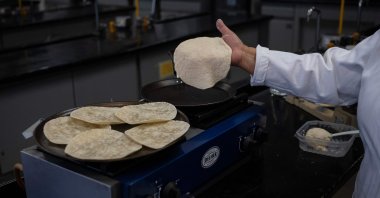 Raquel Gomez Pliego prepares &quot;super tortillas&quot; at the Industrial Microbiology laboratory of the National Autonomous University of Mexico (UNAM), Mexico City, Mexico, April 10, 2025. (AFP Photo)