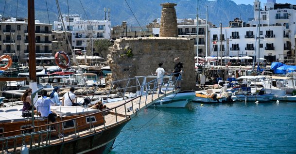 A group of tourists watch the historic Girne Castle from a boat docked at the port of Girne (Kyrenia) on the northern coast of the Turkish Republic of Northern Cyprus (TRNC), May 5, 2025. (AA Photo)