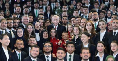 President Recep Tayyip Erdoğan poses with youth at an event at the Presidential Library at the Presidential Complex, Ankara, Türkiye, May 19, 2025. (İHA Photo)