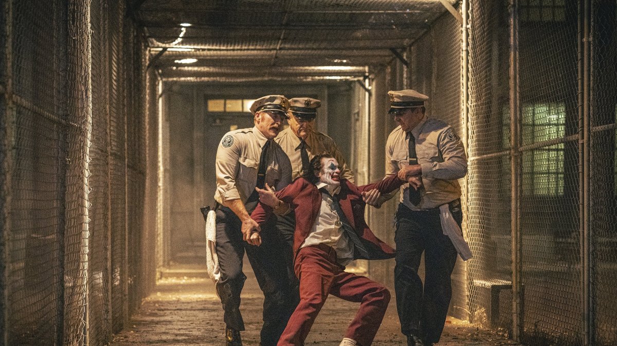 Joaquin Phoenix (foreground C) and Brendan Gleeson (background C) in a scene from &quot;Joker: Folie a Deux.&quot; (AP Photo)