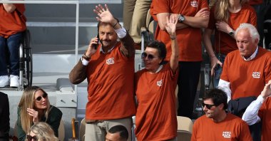 Former French tennis player Henri Leconte waves, next to Jo-Wilfried Tsonga (C, below) during a ceremony honoring Rafael Nadal&#039;s career on Court Philippe-Chatrier at the Roland-Garros Complex, Paris, France, May 25, 2025. (AFP Photo)