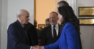 MHP leader Devlet Bahçeli (L) shakes hands with DEM Party co-chair Tülay Hatimoğulları, Ankara, Türkiye, May 27, 2025. (AA Photo)