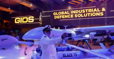 A member of the Pakistan armed forces takes a selfie with an unmanned combat aerial vehicle during IDEAS 2024 in Karachi, Pakistan, Nov. 21, 2024. (Reuters Photo)