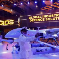 A member of the Pakistan armed forces takes a selfie with an unmanned combat aerial vehicle during IDEAS 2024 in Karachi, Pakistan, Nov. 21, 2024. (Reuters Photo)