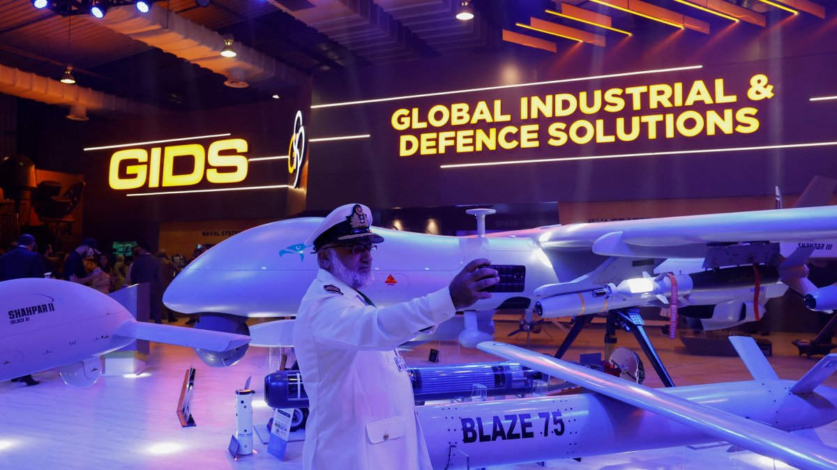 A member of the Pakistan armed forces takes a selfie with an unmanned combat aerial vehicle during IDEAS 2024 in Karachi, Pakistan, Nov. 21, 2024. (Reuters Photo)