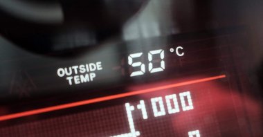 A dashboard display shows an external temperature of 50 degrees Celsius outside a vehicle in Dubai, UAE, May 23, 2025. (AFP Photo)