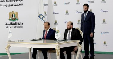 Syrian President Ahmed al-Sharaa stands behind Syrian Energy Minister Mohammed al-Bashir (R) and Kalyon Holding Chairman Orhan Cemal Kalyoncu during a signing ceremony of the Syrian government with four companies to expand the country&#039;s electrical grid by 5,000 megawatts, Damascus, Syria, May 30, 2025. (EPA Photo)