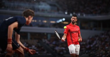 A ball boy passes a ball to Serbia&#039;s Novak Djokovic before serving to Austria&#039;s Filip Misolic during their men&#039;s singles match on day 7 of the French Open tennis tournament on Court Philippe-Chatrier at the Roland-Garros Complex, Paris, France, May 31, 2025. (AFP Photo)