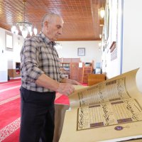 Kasem Hafizi, the mosque&#039;s 78-year-old imam, shows the preserved Quran at the mosque, Tirana, Albania, May 31, 2025. (AA Photo)