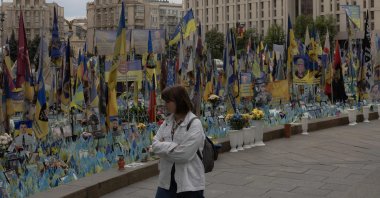 A woman visits a memorial for the fallen Ukrainian and foreign fighters on the Independence Square in Kyiv, Ukraine, May 14, 2025. (AFP Photo)