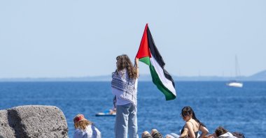 Climate activist Greta Thunberg waves the Palestinian flag before boarding the Madleen departed from the port of Catania, Sicily, Italy, June 1, 2025. (AA Photo)