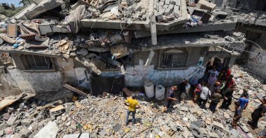People inspect the damage at the site of an Israeli strike that targeted a house in the Nuseirat camp for Palestinian refugees, central Gaza Strip, Palestine, June 1, 2025. (AFP Photo)