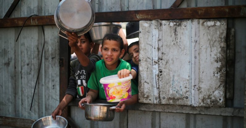 Palestinian children reach out with their pots as they wait for food at a distribution point in Nuseirat, central Gaza Strip, Palestine, June 2, 2025. (AFP Photo)