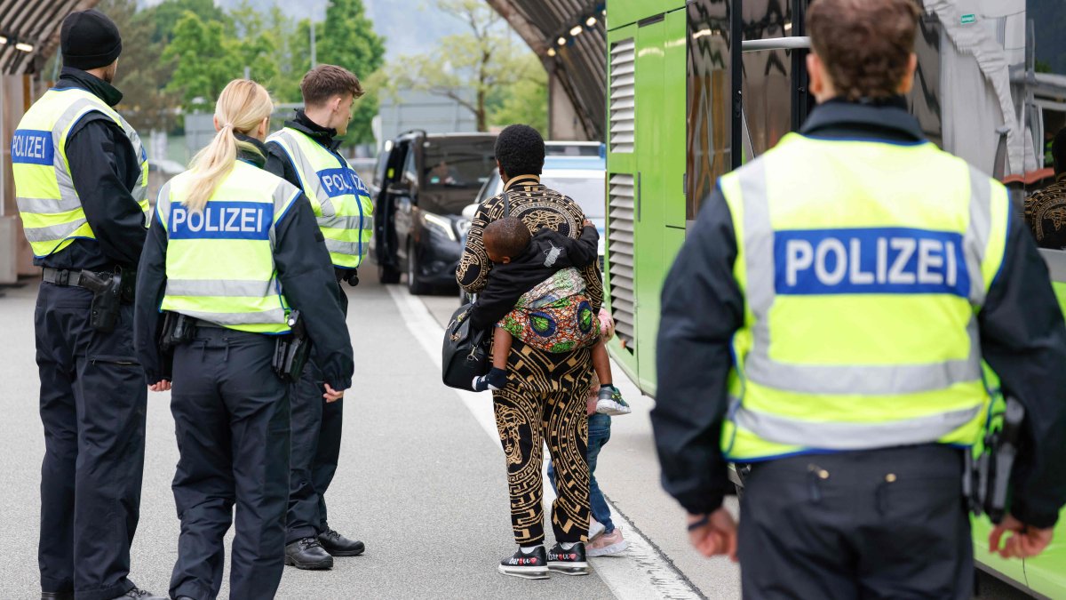 A Nigerian woman and her two children are escorted by German federal police officers after being required to disembark from a tourist bus at the Kiefersfelden border control station in southern Germany, upon entering from Austria, May 9, 2025. (AFP File Photo)